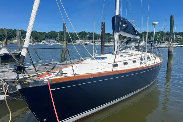 Slide: The Image of 2002 Sabre 452 sailboat docked in a marina under clear blue skies. - 53