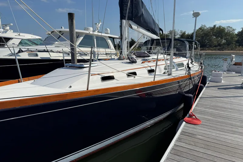 Slide: The Image of 2002 Sabre 452 sailboat docked at marina under clear blue sky. - 57