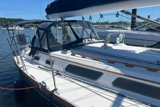Slide: The Image of Sailboat Sabre 452, 2002 model, docked at marina under clear blue sky. - 7