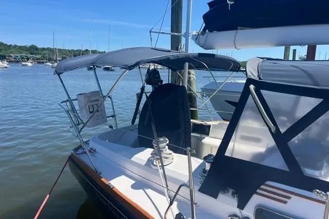 Slide: The Image of 2002 Sabre 452 sailboat docked in a marina, featuring a shaded cockpit and clear skies. - 8