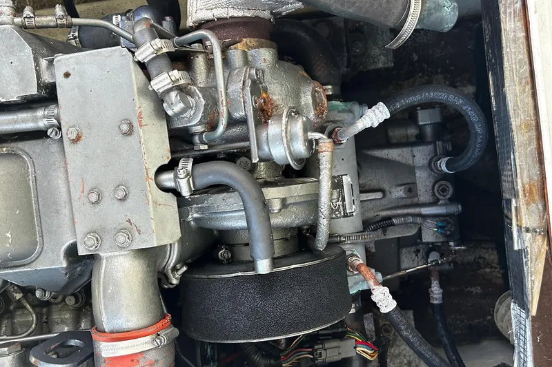 Slide: The Image of Engine compartment of a 2000 Albin 28 Tournament Express boat, showing detailed mechanical components. - 12