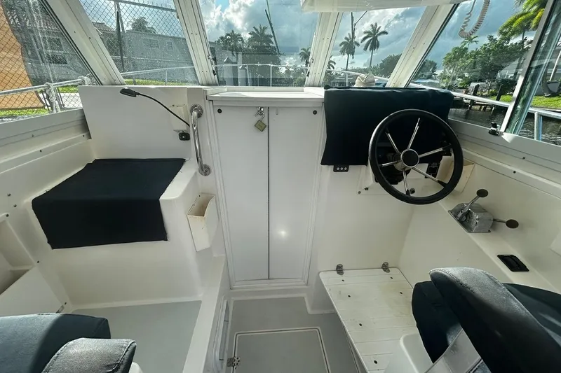 Slide: The Image of Interior of 2000 Albin 28 Tournament Express boat with steering wheel and seating. - 15