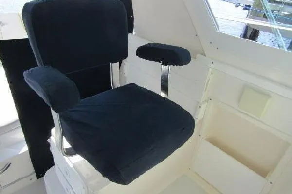 Slide: The Image of Captain's chair on 2000 Albin 28 Tournament Express boat, featuring black upholstery. - 16