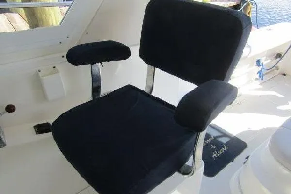 Slide: The Image of Boat seat on 2000 Albin 28 Tournament Express, featuring black upholstery and metal armrests. - 17