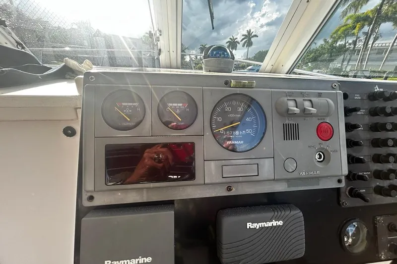 Slide: The Image of Dashboard of a 2000 Albin 28 Tournament Express boat with Yanmar controls and Raymarine equipment. - 19
