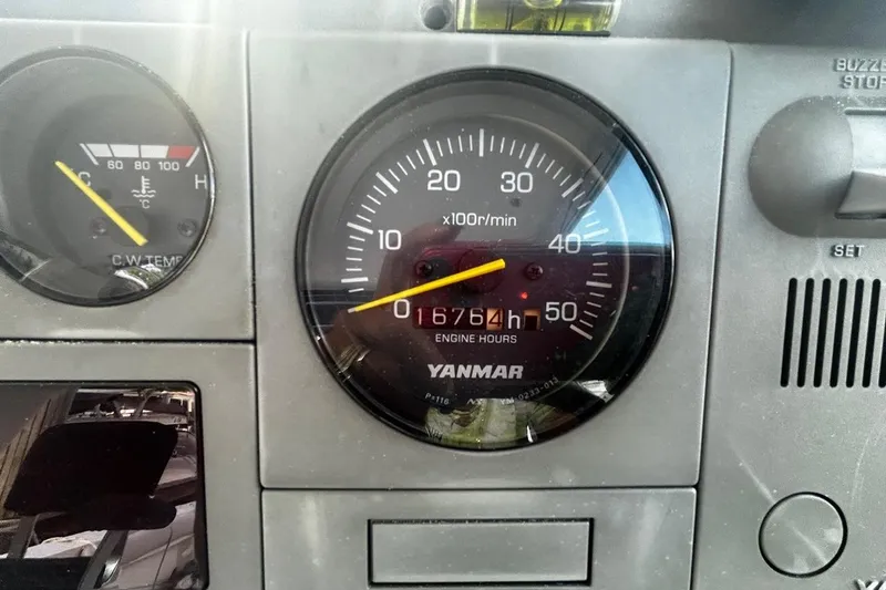 Slide: The Image of Dashboard of a 2000 Albin 28 Tournament Express showing engine hours and temperature gauges. - 20