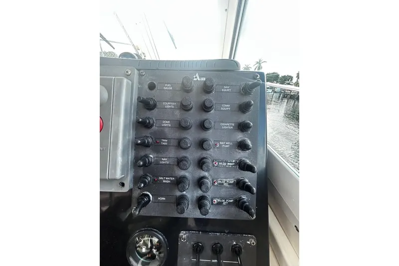 Slide: The Image of Control panel of a 2000 Albin 28 Tournament Express boat with various switches. - 21