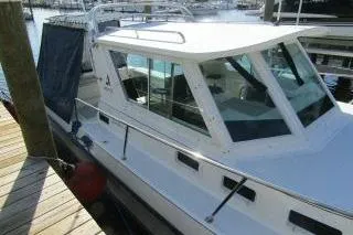 Slide: The Image of 2000 Albin 28 Tournament Express boat docked at a marina. - 3