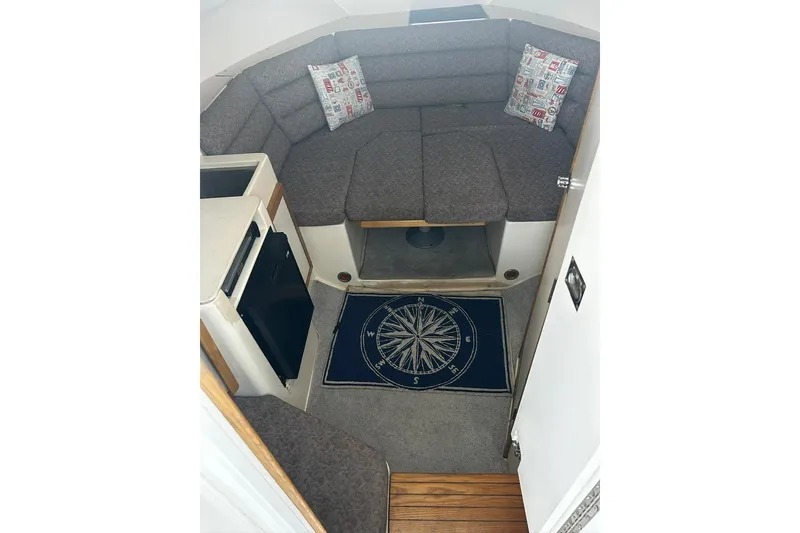 Slide: The Image of Interior of 2000 Albin 28 Tournament Express with cozy seating and nautical-themed decor. - 31