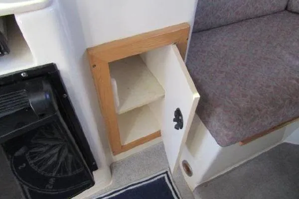 Slide: The Image of Open storage compartment in 2000 Albin 28 Tournament Express boat interior. - 35