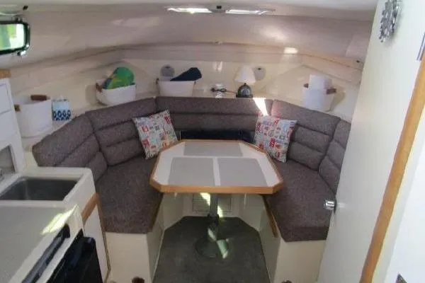 Slide: The Image of Interior of 2000 Albin 28 Tournament Express with cozy seating and dining area. - 38