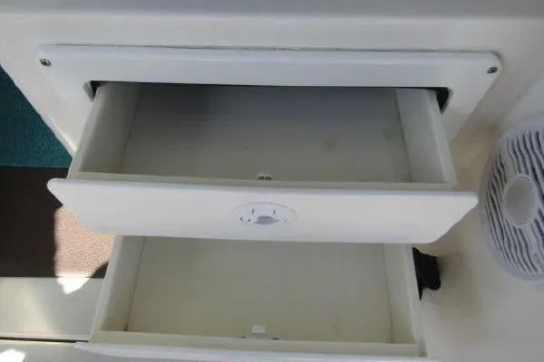 Slide: The Image of Open storage compartment on a 2000 Albin 28 Tournament Express boat. - 41