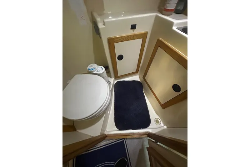 Slide: The Image of Compact bathroom in 2000 Albin 28 Tournament Express boat with toilet and storage cabinets. - 44