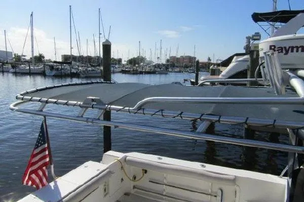 Slide: The Image of 2000 Albin 28 Tournament Express docked at marina with American flag. - 6