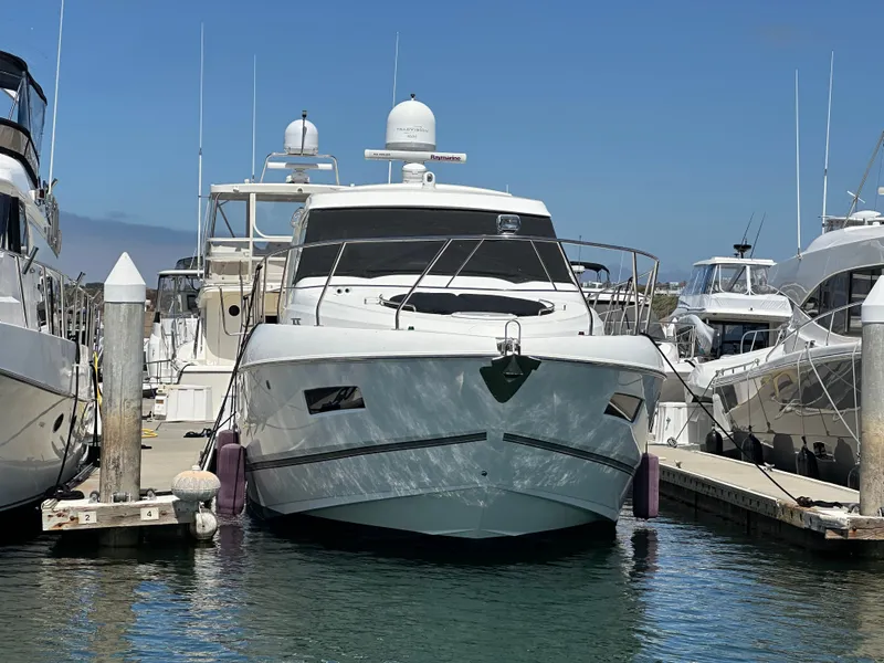 Slide: The Image of 2014 Cruisers Yachts 48 Cantius docked, surrounded by other boats. - 11