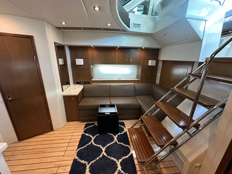 Slide: The Image of Interior of 2014 Cruisers Yachts 48 Cantius with leather sofa and wooden stairs. - 19