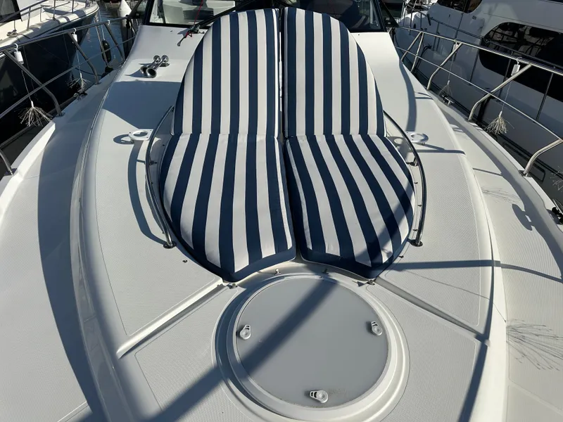 Slide: The Image of 2014 Cruisers Yachts 48 Cantius with striped sun loungers. - 2