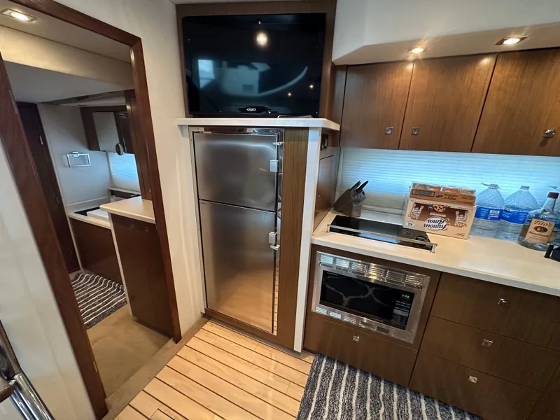 Slide: The Image of Interior of 2014 Cruisers Yachts 48 Cantius with kitchen and TV. - 25