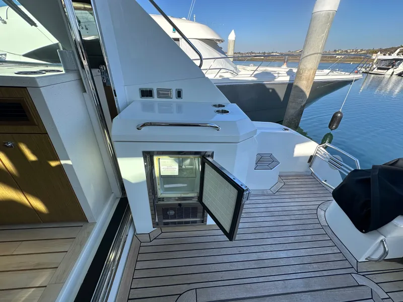 Slide: The Image of 2014 Cruisers Yachts 48 Cantius on water with open fridge door. - 30