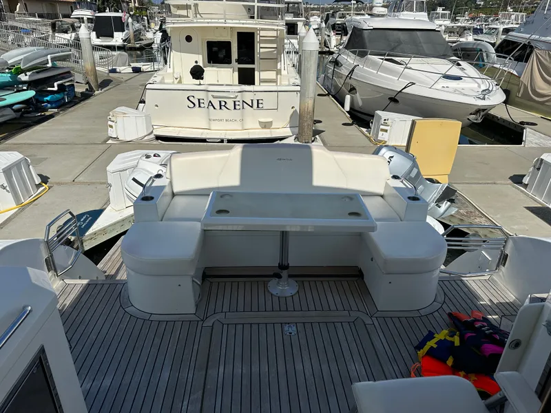 Slide: The Image of 2014 Cruisers Yachts 48 Cantius docked, featuring seating area. - 46