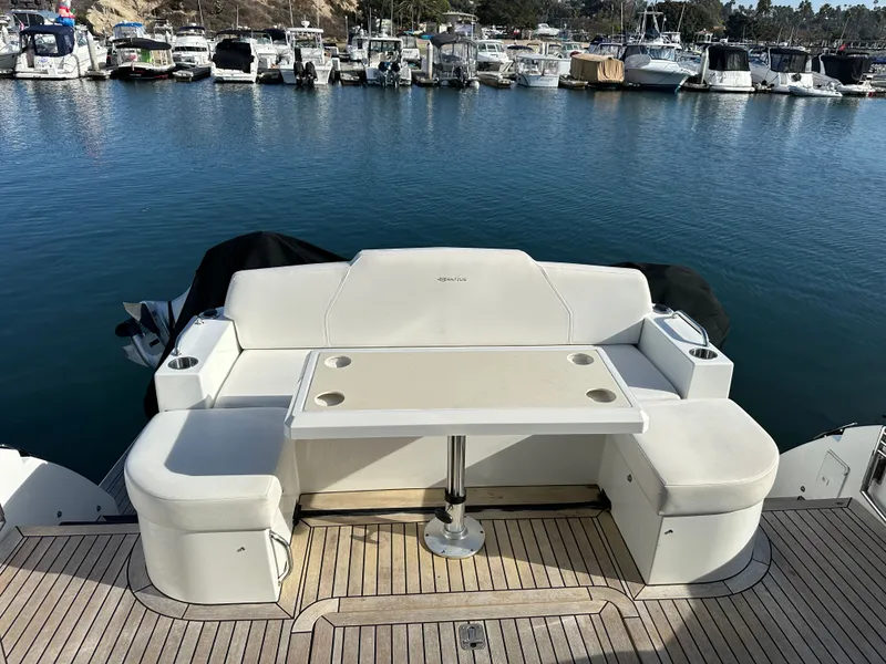 Slide: The Image of 2014 Cruisers Yachts 48 Cantius in harbor with seating area. - 47