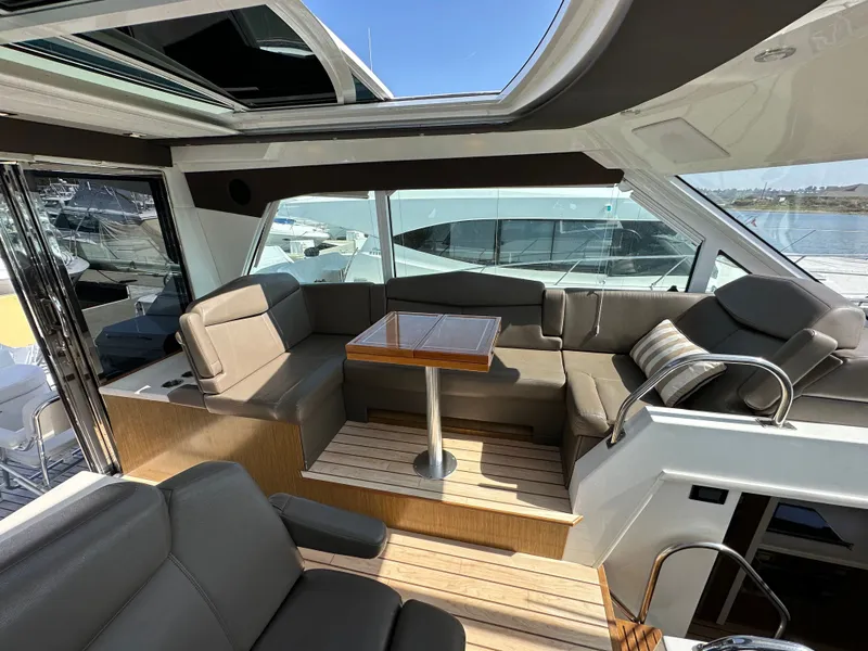 Slide: The Image of Interior of 2014 Cruisers Yachts 48 Cantius with seating area and table. - 49