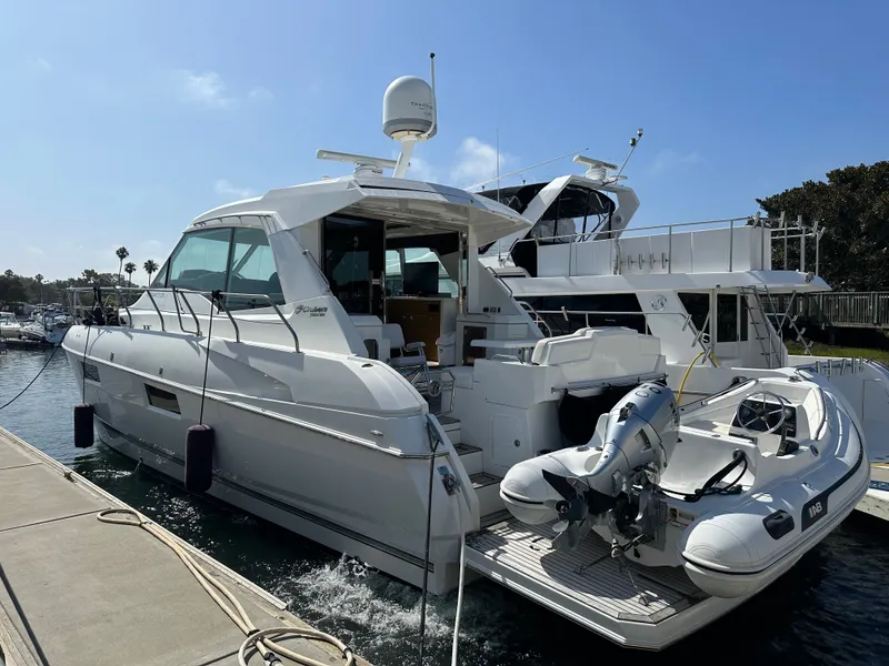 Slide: The Image of 2014 Cruisers Yachts 48 Cantius docked with tender boat. - 8