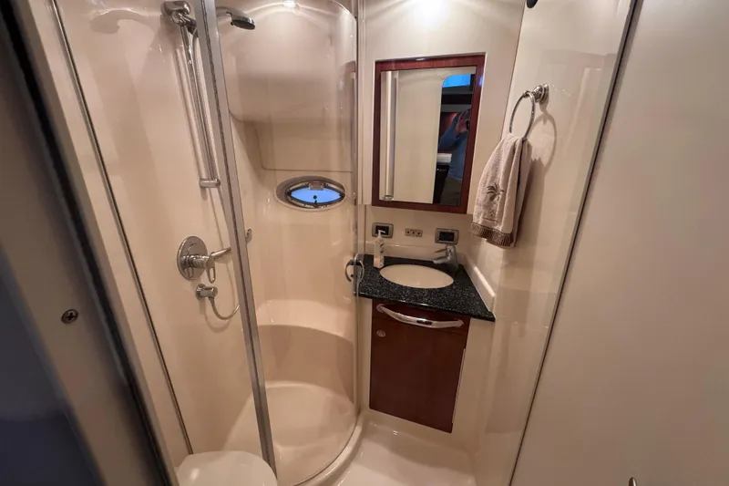 Slide: The Image of Luxurious 2004 Sea Ray 390 Motor Yacht cabin with elegant wood finishes and cozy bedding. - 21