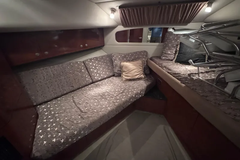 Slide: The Image of Luxurious 2004 Sea Ray 390 Motor Yacht interior with elegant wood finishes and cozy bedroom. - 22