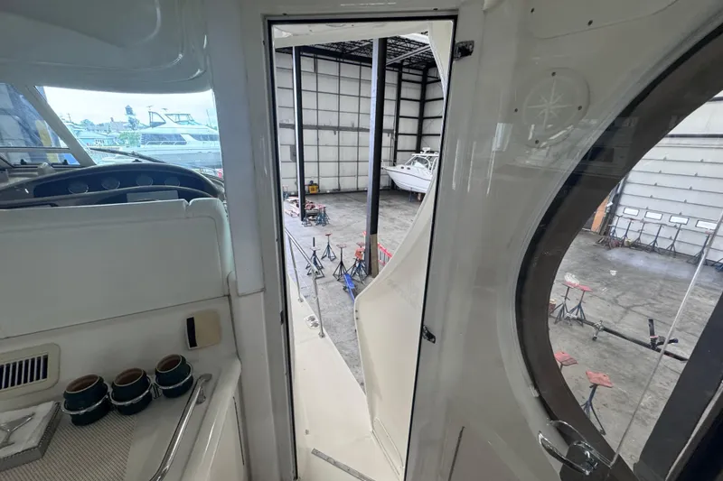 Slide: The Image of 2004 Sea Ray 390 Motor Yacht interior view, showing cockpit and open door to marina. - 40