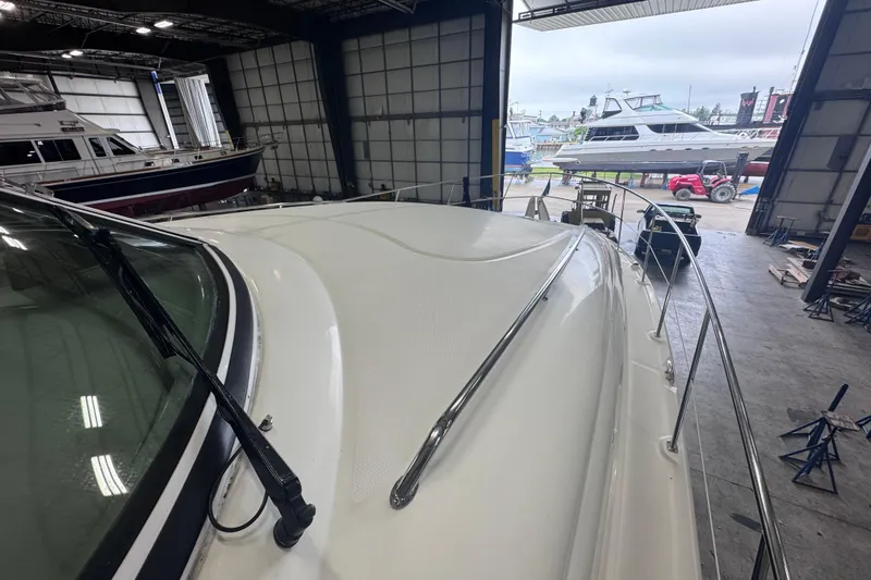 Slide: The Image of 2004 Sea Ray 390 Motor Yacht in a boatyard, surrounded by other vessels. - 41