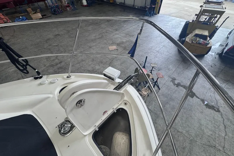 Slide: The Image of 2004 Sea Ray 390 Motor Yacht bow with open storage compartment in a workshop. - 43