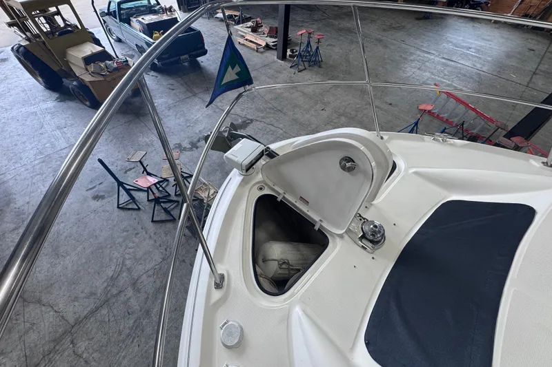 Slide: The Image of 2004 Sea Ray 390 Motor Yacht in a workshop, open hatch, and visible equipment. - 44