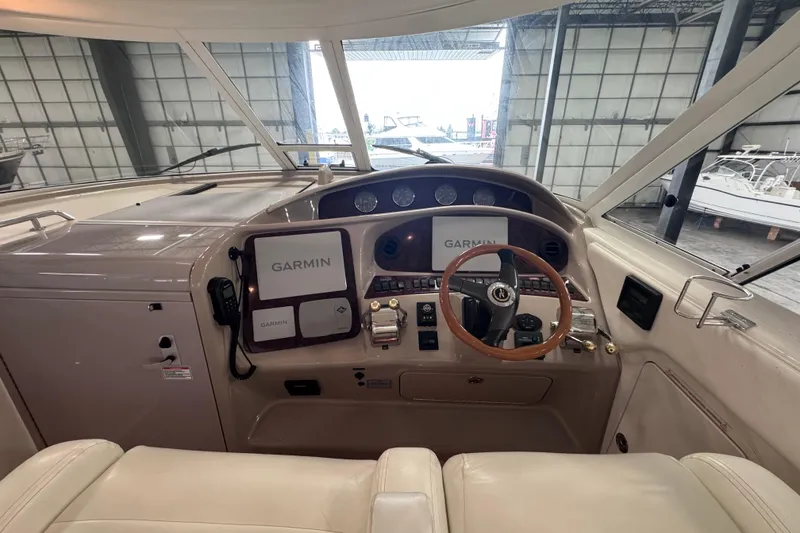 Slide: The Image of 2004 Sea Ray 390 Motor Yacht interior with white seating and table in a spacious cabin. - 8