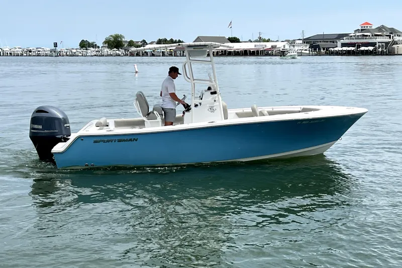 Slide: The Image of 2022 Sportsman Open 212 Center Console boat on calm water, with a Yamaha outboard motor. - 10