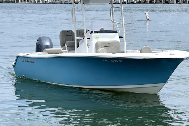 Slide: The Image of 2022 Sportsman Open 212 Center Console boat on calm water, featuring a sleek blue design. - 11