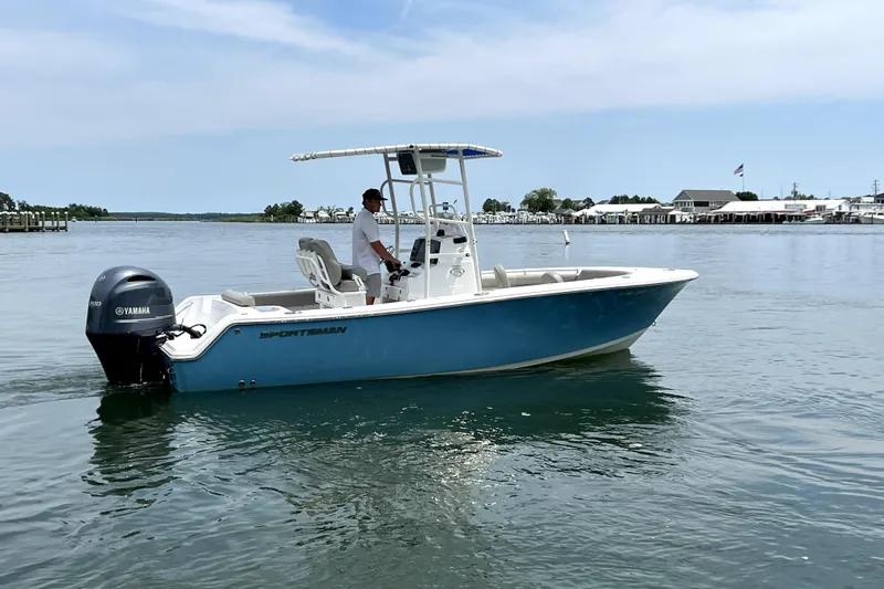 Slide: The Image of 2022 Sportsman Open 212 Center Console boat on calm water, featuring a Yamaha outboard motor. - 12