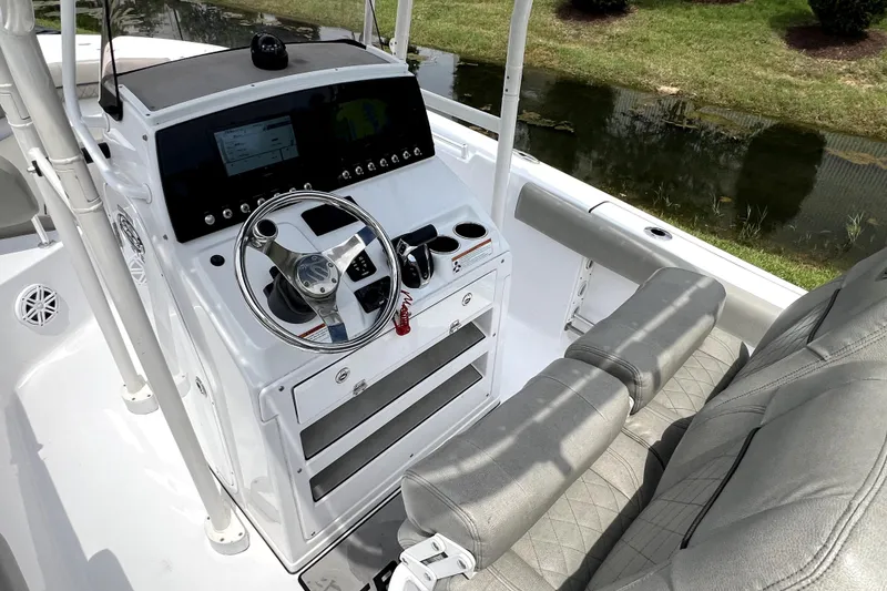Slide: The Image of 2022 Sportsman Open 212 Center Console boat interior with steering wheel and seating. - 16
