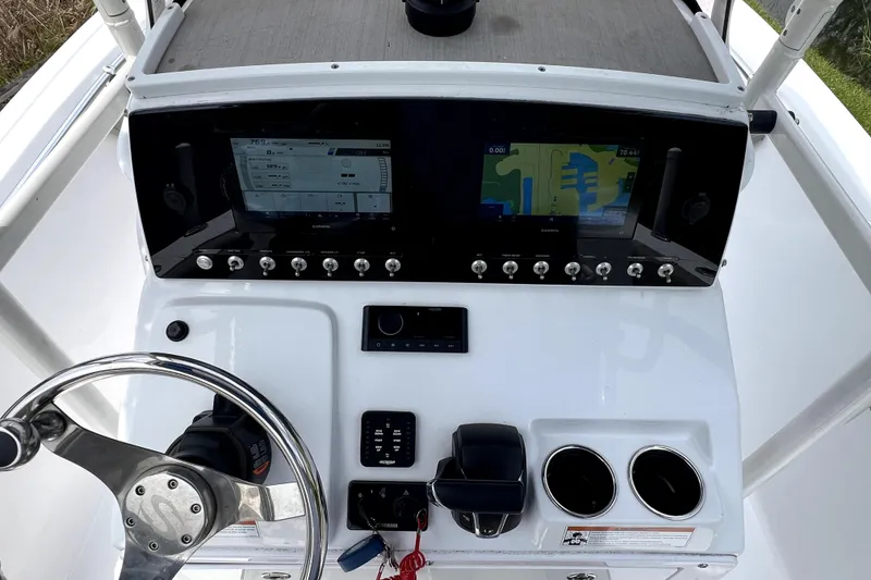 Slide: The Image of 2022 Sportsman Open 212 Center Console dashboard with dual displays and steering wheel. - 18