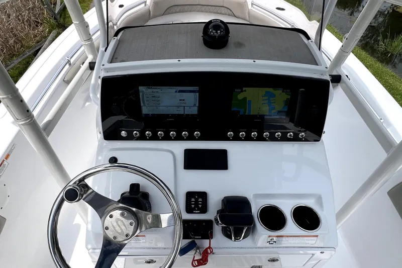 Slide: The Image of 2022 Sportsman Open 212 Center Console dashboard with steering wheel and navigation display. - 19