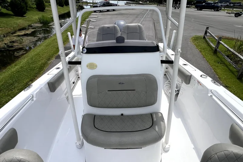 Slide: The Image of 2022 Sportsman Open 212 Center Console boat with cushioned seating and sleek design. - 21