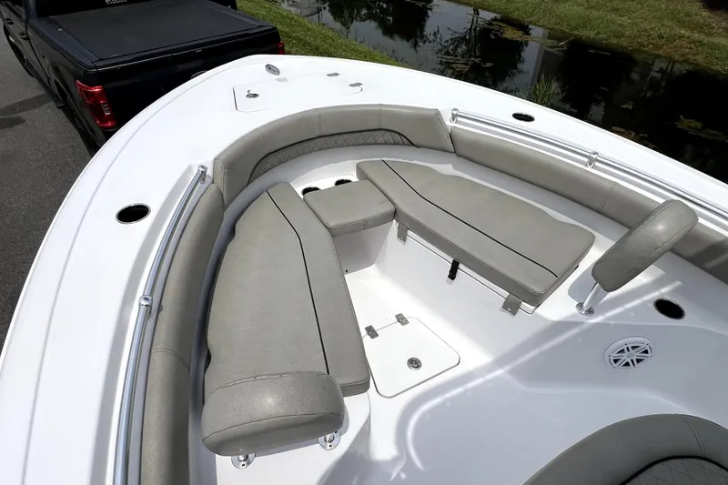 Slide: The Image of 2022 Sportsman Open 212 Center Console boat with cushioned seating and storage compartments. - 22
