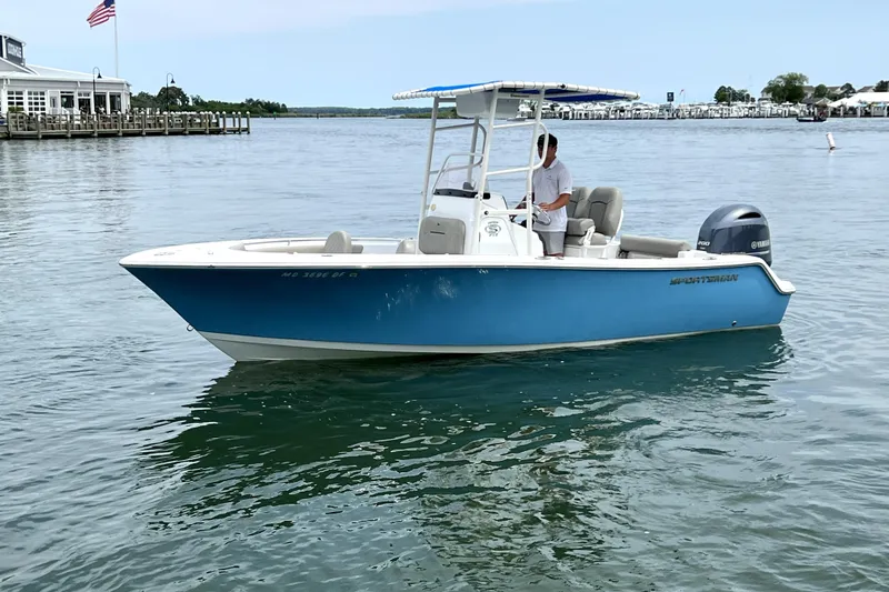 Slide: The Image of 2022 Sportsman Open 212 Center Console boat on calm water near a dock. - 5