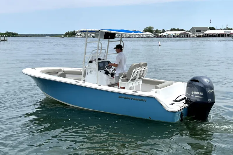Slide: The Image of 2022 Sportsman Open 212 Center Console boat on calm water with Yamaha engine. - 6
