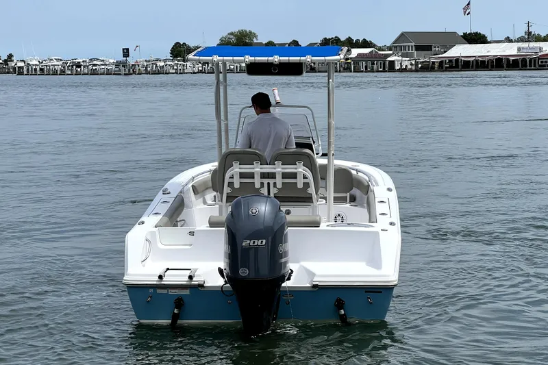 Slide: The Image of 2022 Sportsman Open 212 Center Console boat on water, rear view with outboard motor. - 8