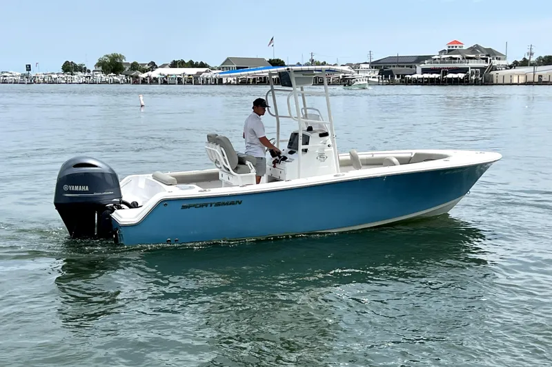 Slide: The Image of 2022 Sportsman Open 212 Center Console boat on calm water, featuring a Yamaha engine. - 9