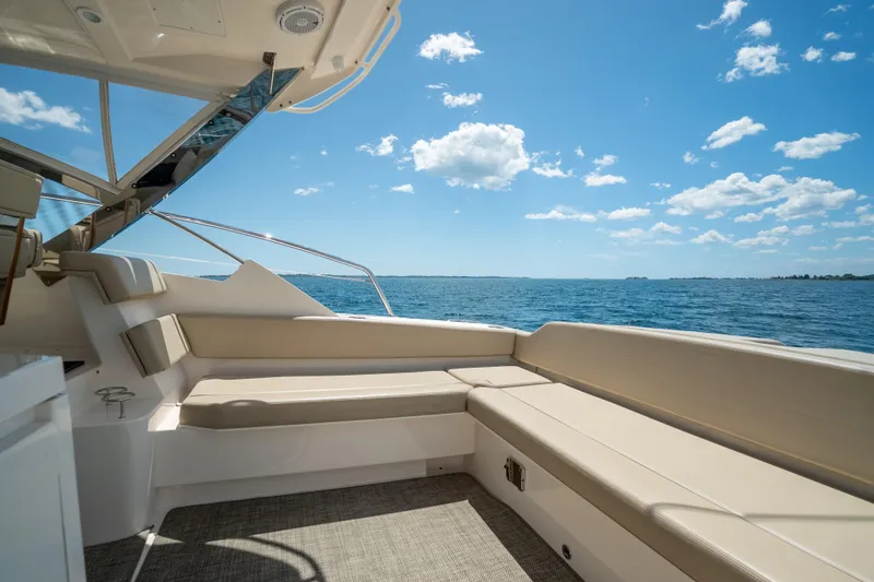 Slide: The Image of 2015 Pursuit SC 365i Sport Coupe interior with ocean view and comfortable seating. - 13