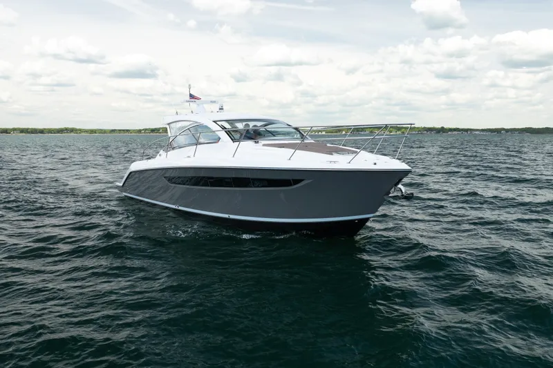 Slide: The Image of 2015 Pursuit SC 365i Sport Coupe cruising on open water under cloudy skies. - 2