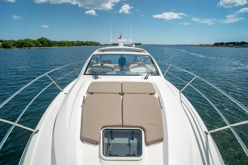 Slide: The Image of 2015 Pursuit SC 365i Sport Coupe cruising on a sunny day, showcasing sleek design and comfort. - 22