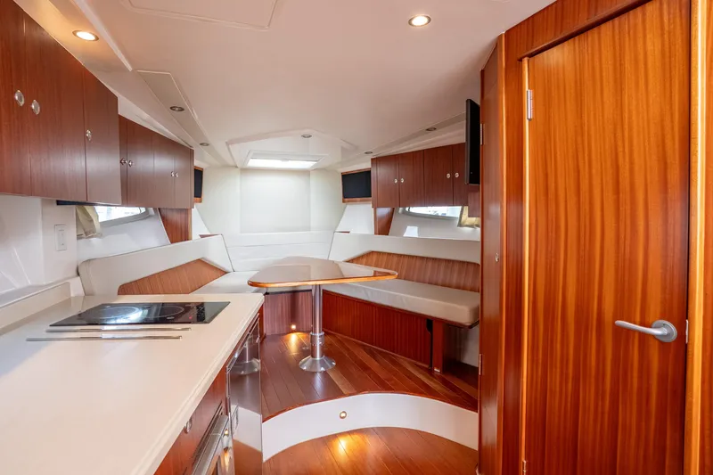 Slide: The Image of Luxurious interior of 2015 Pursuit SC 365i Sport Coupe with wood finishes and modern amenities. - 24